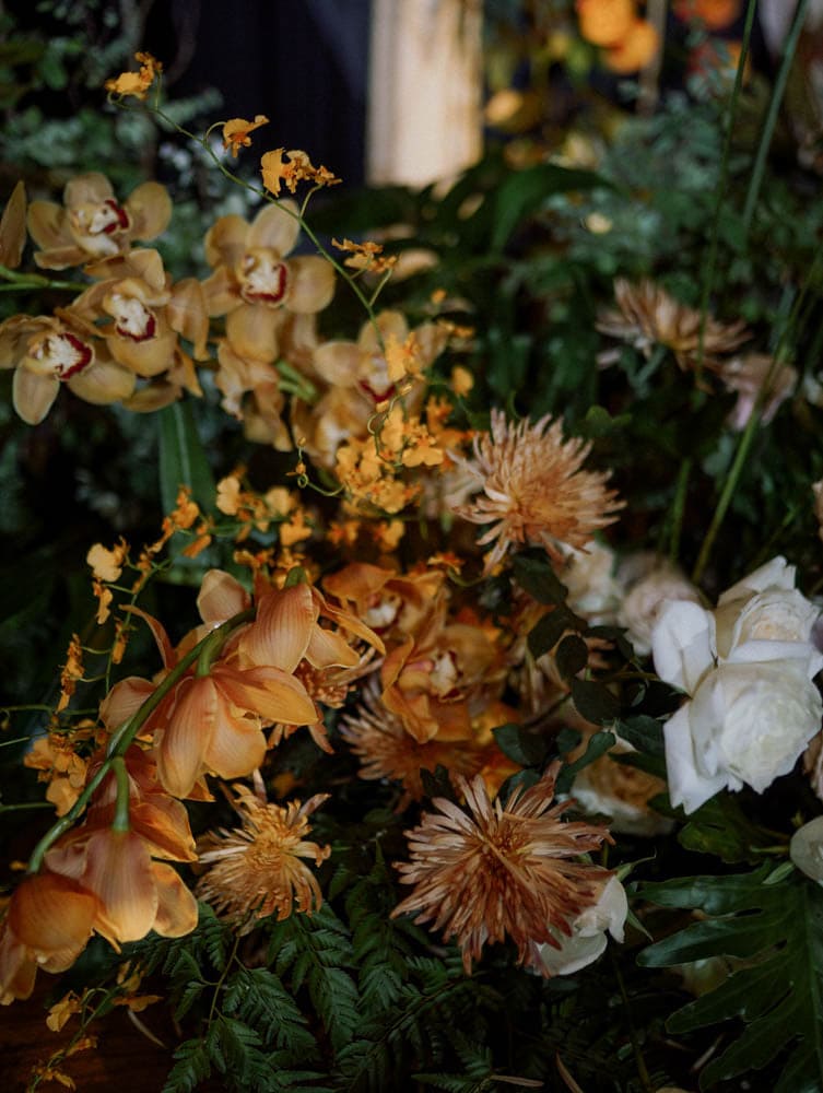 Rich-toned floral arrangement with natural lighting at Capella Hotel.