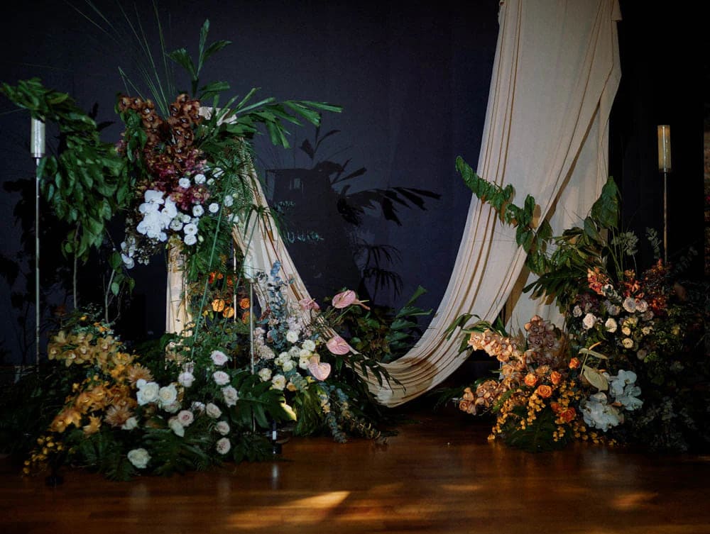 Full view of stage setup as backdrop with tropical florals at Capella Hotel Singapore.