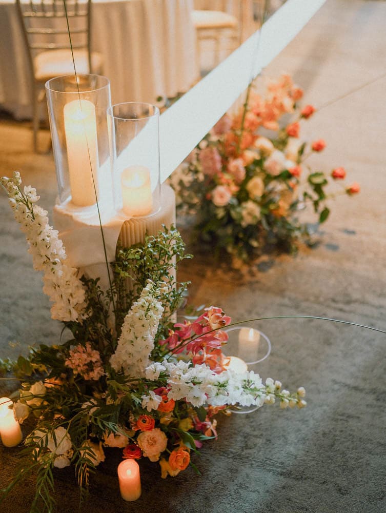 Tropical wedding aisle at Capella Hotel Singapore with candles and lush florals.
