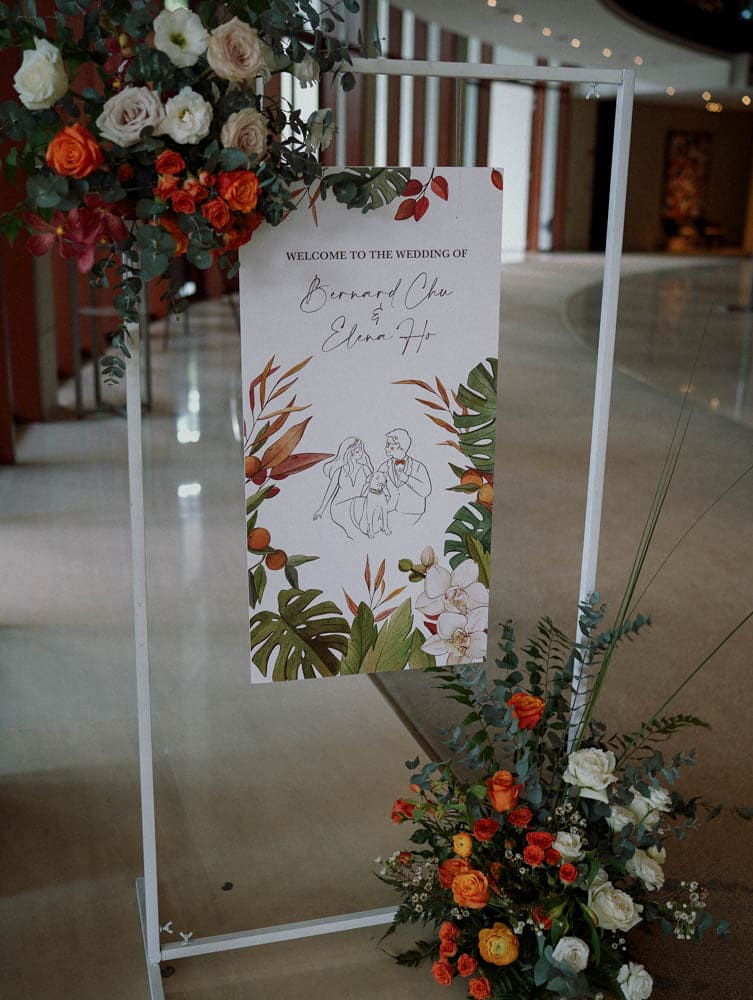 Full view of welcome signage with lush floral base at Capella Hotel Singapore.