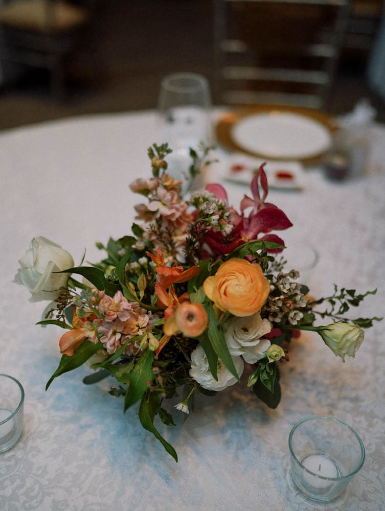 Close-up of textured centerpiece with lush floral in tropical wedding theme at Capella Hotel Singapore