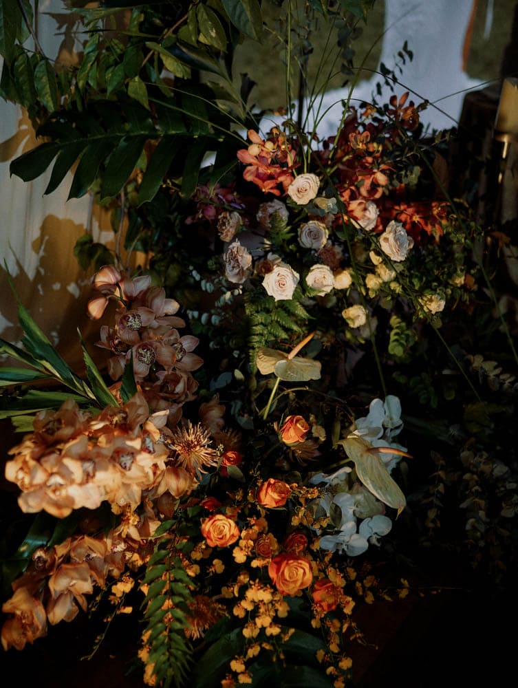 Rich-toned floral tropical arrangement with natural lighting at Capella Hotel Singapore.