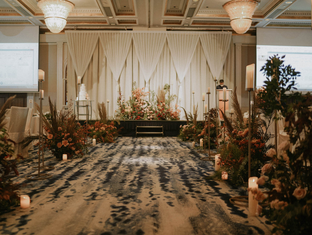 Wide ballroom shot of autumn garden wedding styling with stage landscape florals and aisle hedges at Four Seasons Hotel Singapore