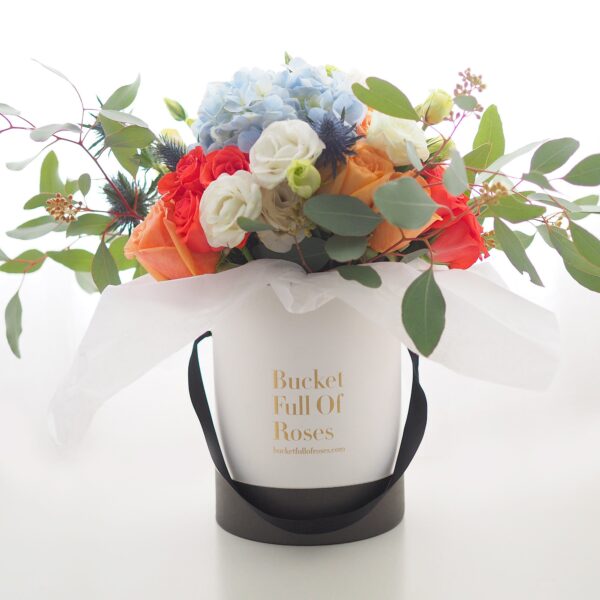 Wild flowers roses floral arrangement bucket