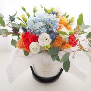 Wild flowers roses floral arrangement bucket