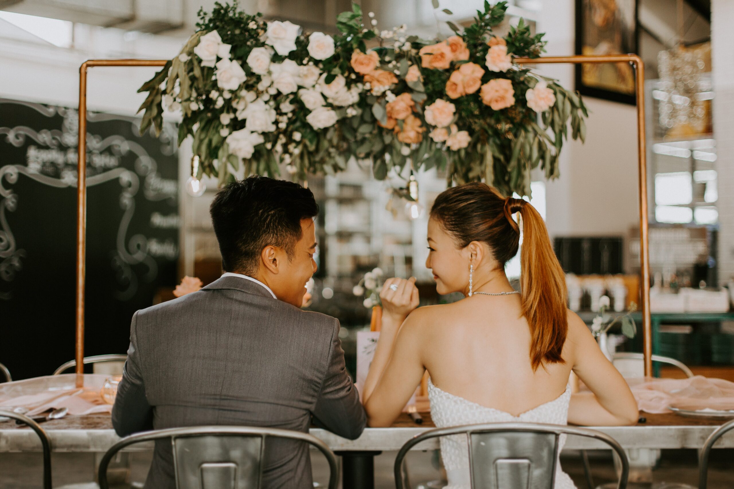 Unique wedding photography venue photo pose for wedding couples back facing showing wedding ring shot in industrial theme wedding