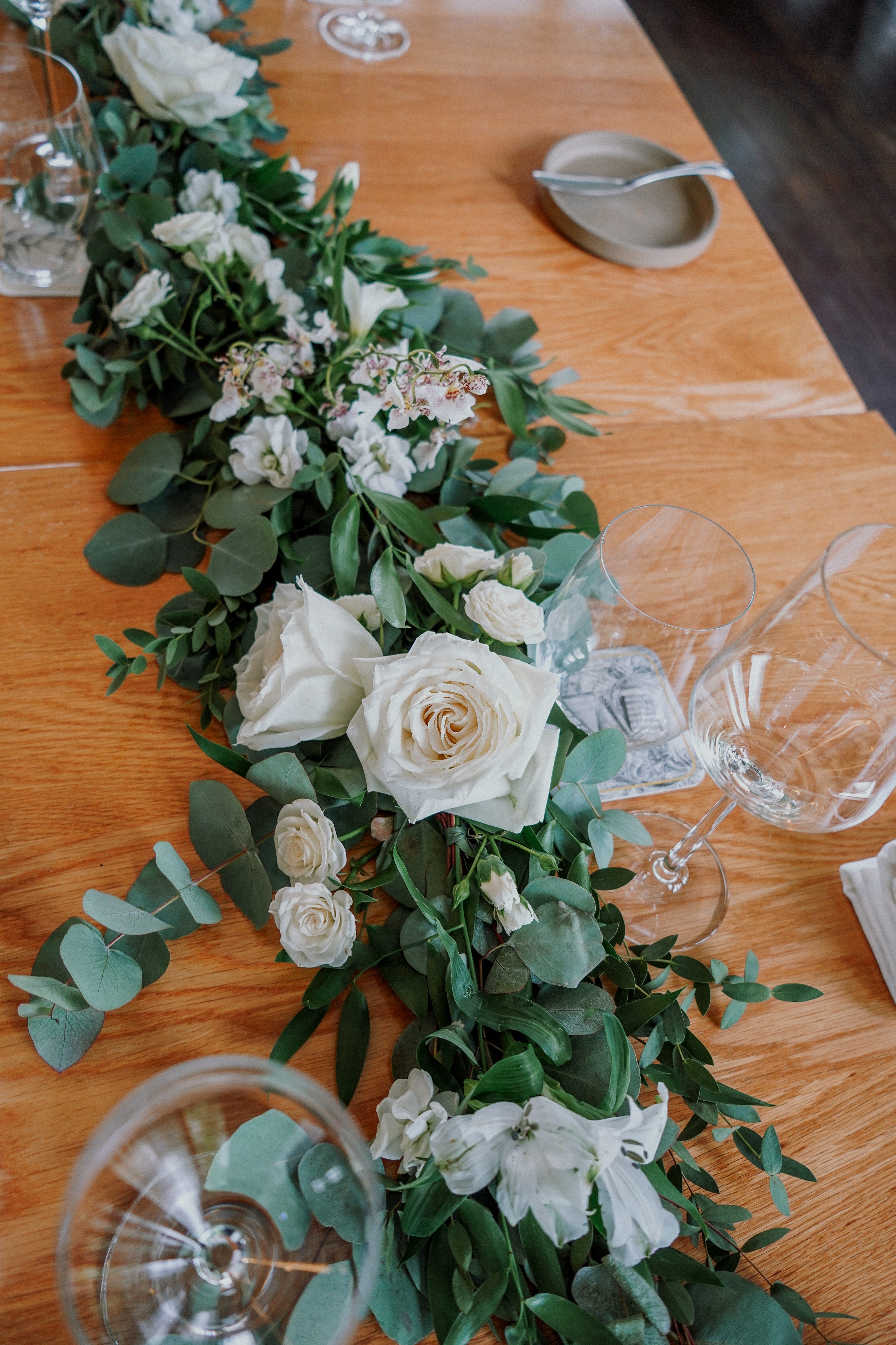 Ideas for wedding flowers white and green colour palette garden theme on long dinner table for wedding lunch ceremony at Corner House Singapore