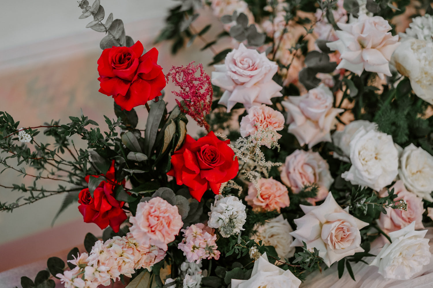 Close up of church wedding florist Singapore red colour palette 2022 flowers ideas