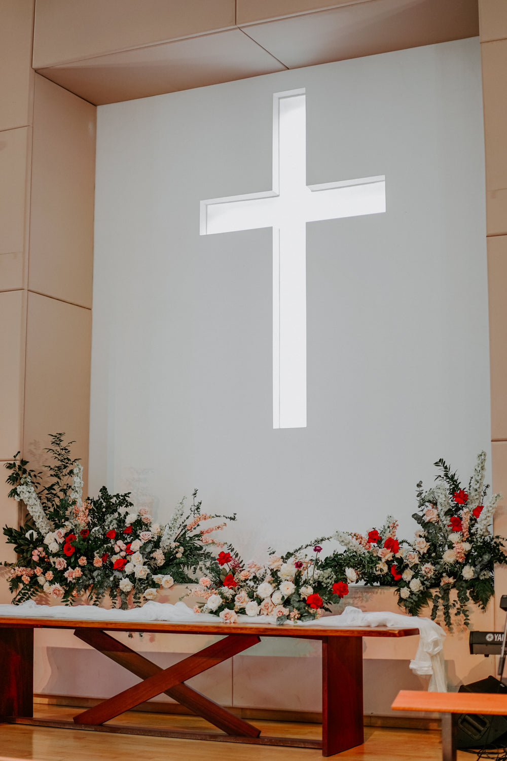 Wedding church Singapore decorations flowers at front of altar with white background and cross