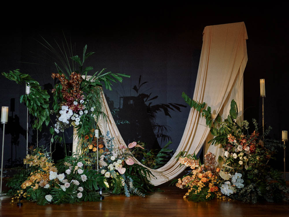 Landscape full view of stage setup for a backdrop with tropical florals at Capella Hotel Singapore.