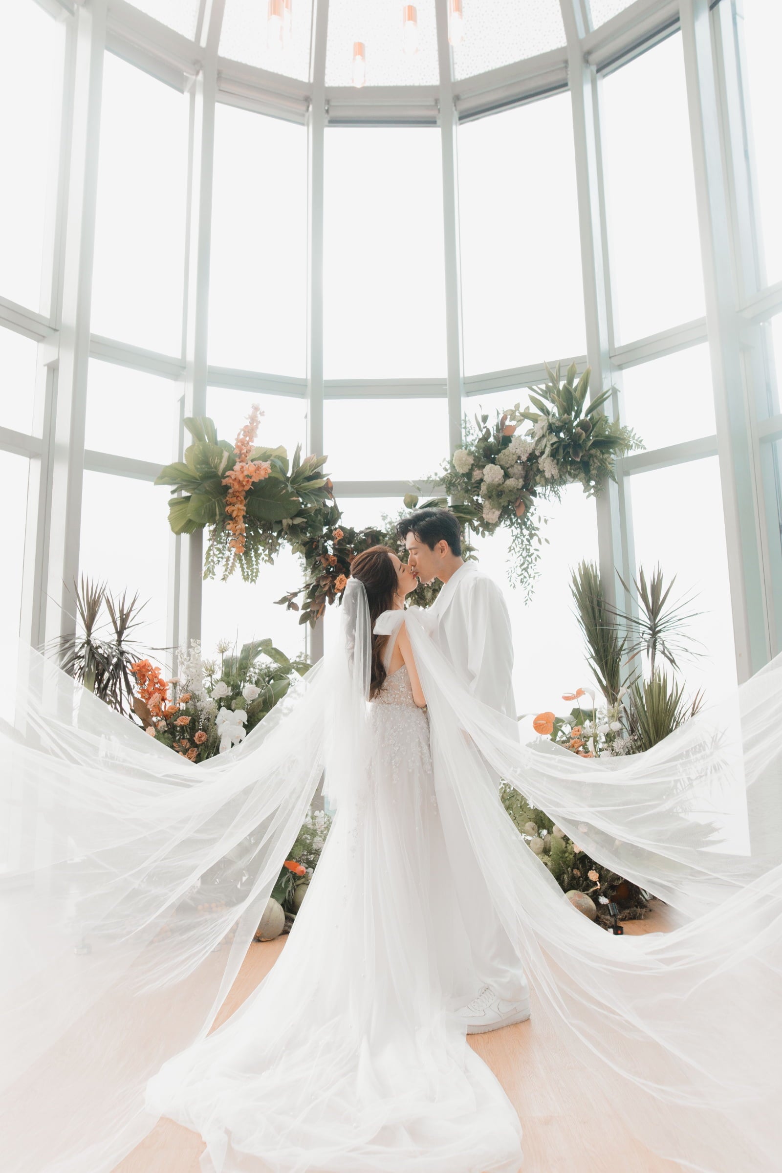 Nicole bridal gowns with James Seah actor in Singapore wedding 1 Atico floating floral arch wedding flower ideas