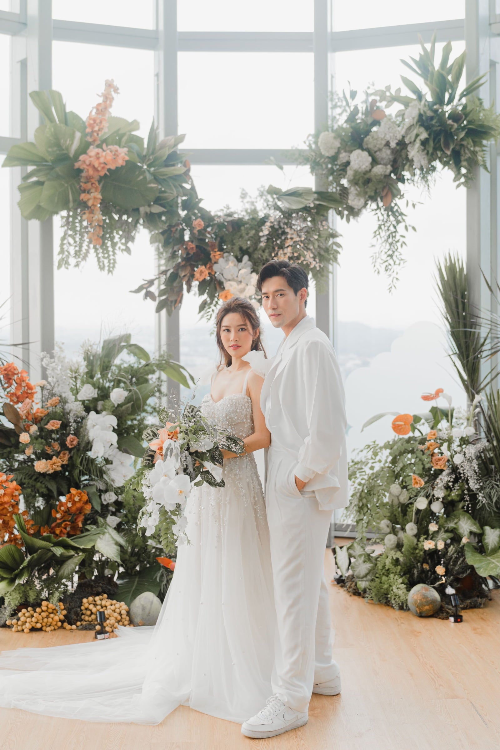 James Seah wife Nicole Chang Min in front of floating floral installation at 1-Atico glass dome in January 2022 wedding planning inspo