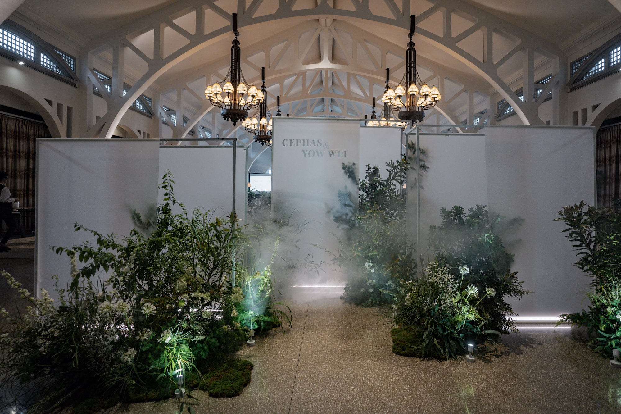 Translucent backdrop panels creating a mist-like effect for a woodland-inspired event at Clifford Pier