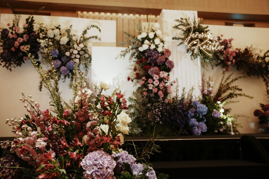 Wide cinematic shot of the full ceremony floral installation in Edition Hotel’s ballroom.