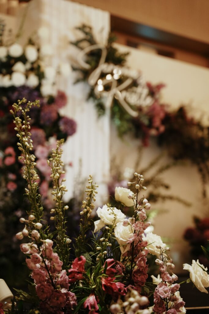 Close-up of garden-style floral arrangement with pink delphiniums, purple hydrangeas, and white roses at Edition Hotel Singapore.