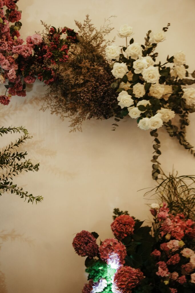 Structured purple tones floral backdrop with cascading wild garden blooms.
