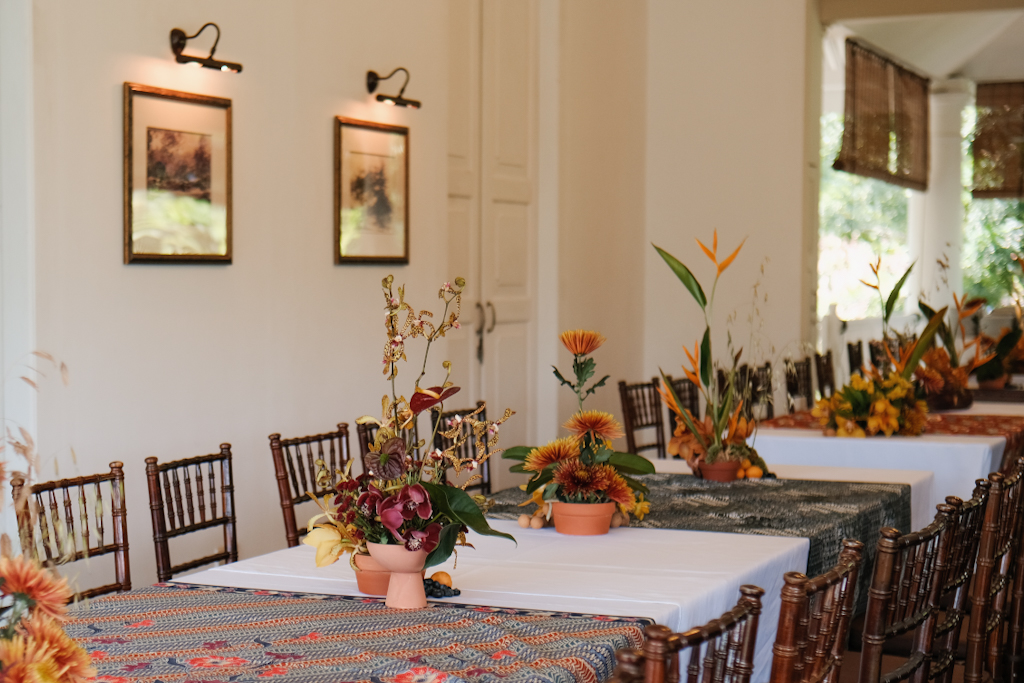 Wedding reception table styled with native florals and tropical fruits