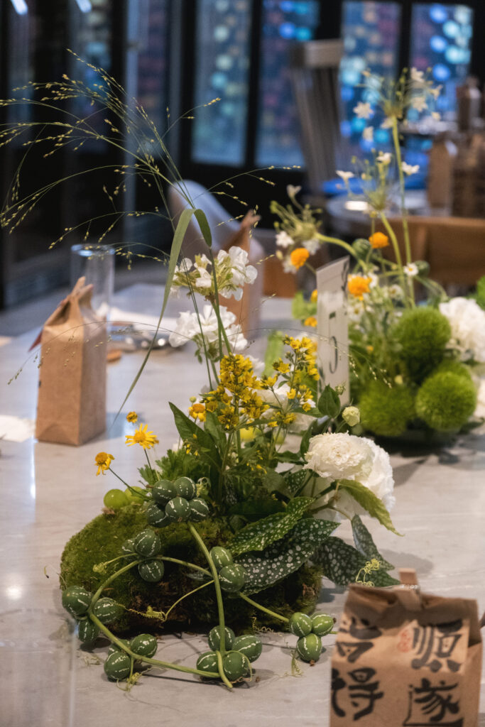 Close-up of dainty wildflower filler blooms in soft yellow and white, adding delicate texture to the wedding tablescape.