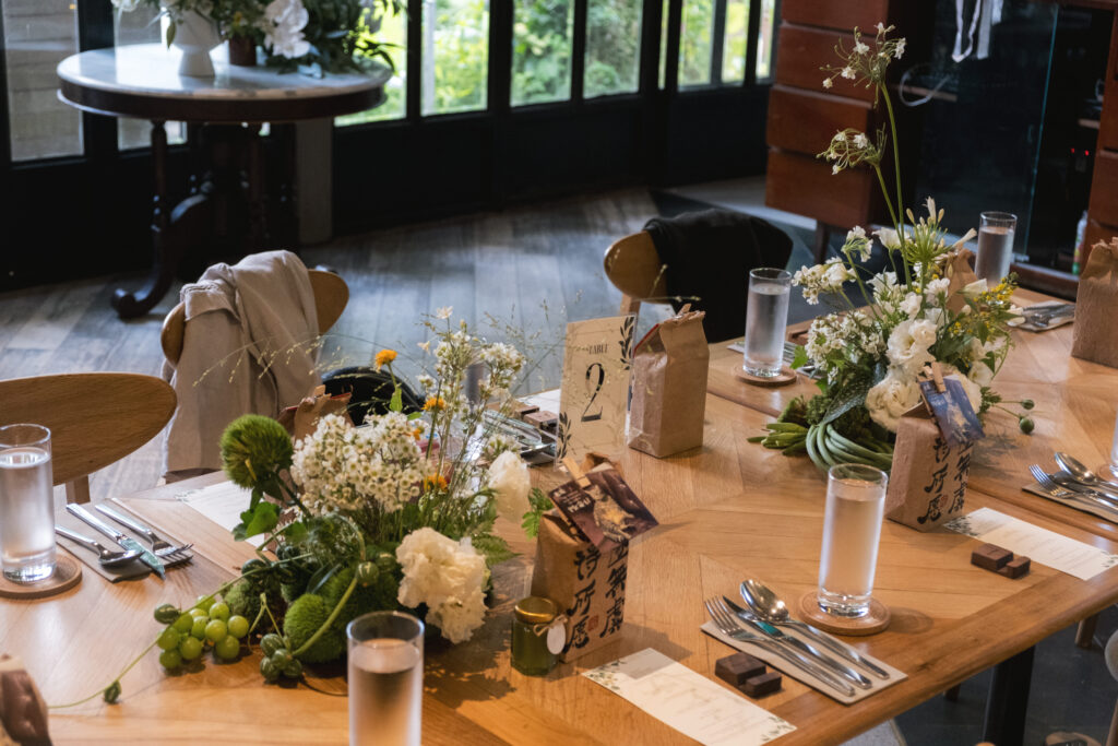 Various centerpiece with slightly varied floral arrangements, creating interest across the table at Open Farm Community.
