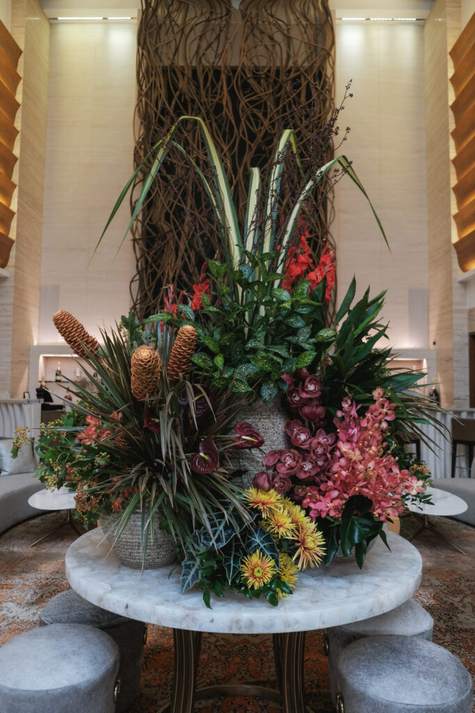 Towering bold red and yellow floral display adding drama to Hotel Michael’s entrance.