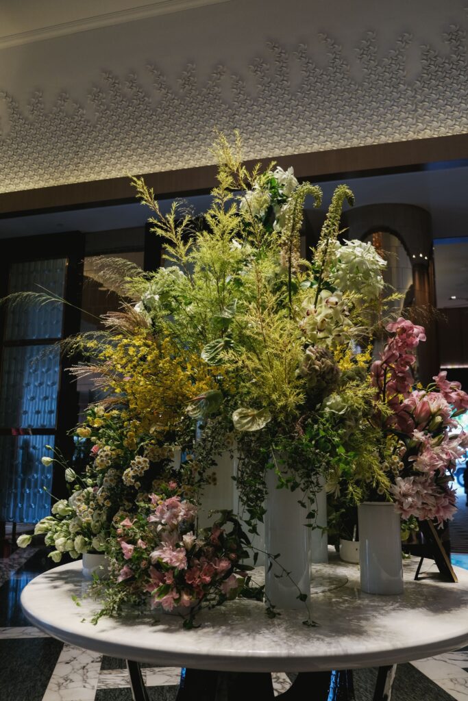 Corporate floral installation with pastel pink, white, and yellow blooms for Resorts World Sentosa.