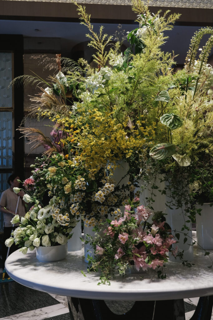 Table floral towers with pastel blooms creating dramatic entrance decor at Hotel Michael.