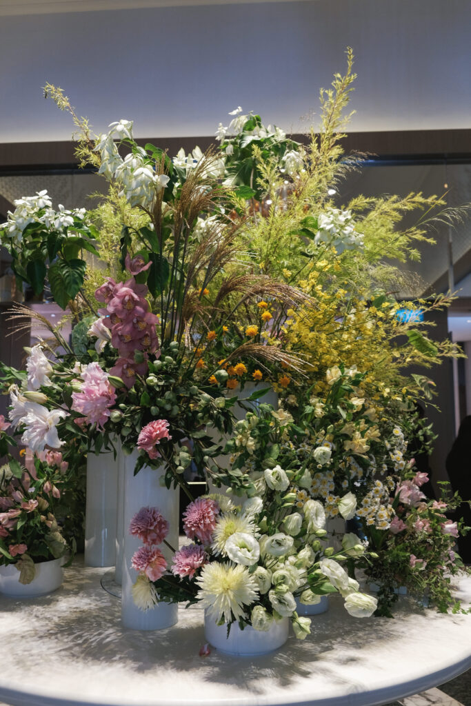 Fresh garden-inspired florals adding soft luxury to Hotel Michael’s reception space.