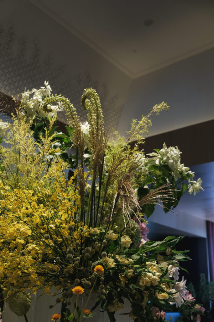 Elegant tall garden-style pastel floral design complementing Hotel Michael’s marble lobby table.