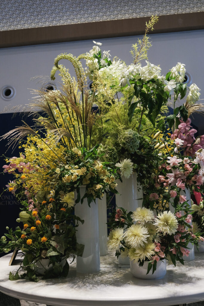 Bright and airy arrangement with yellow and white flowers perfect for corporate events.
