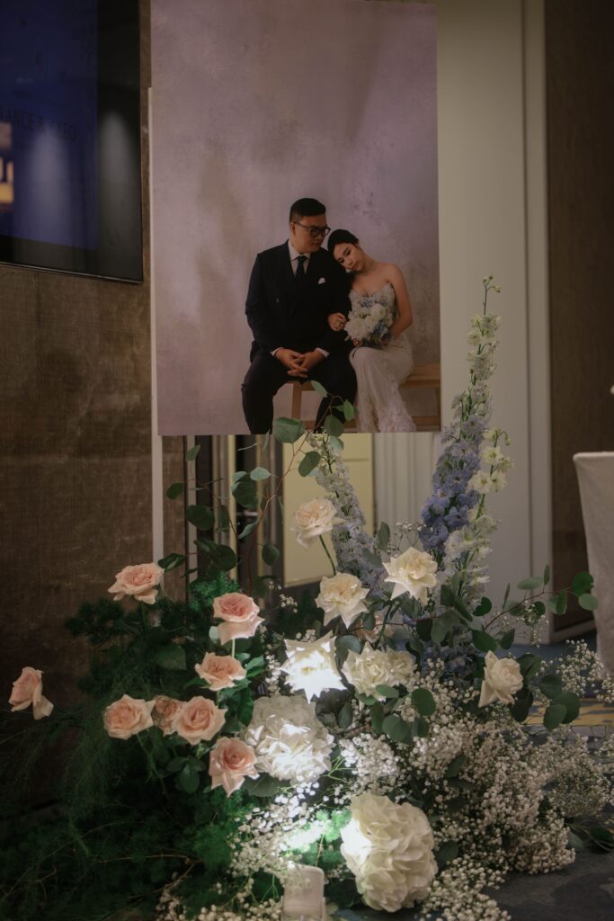 Floral arrangement at the ballroom entrance with soft romantic blooms and layered greenery, Shangri-La Singapore