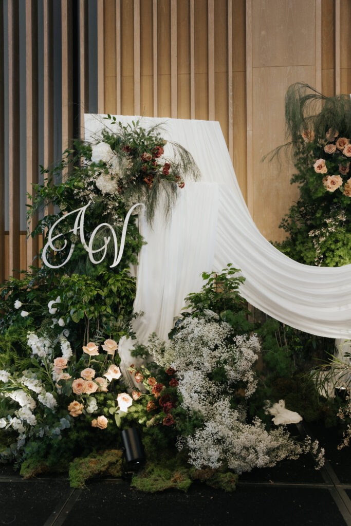 Full antique garden wedding stage with layered florals and soft drapery in white brown green palette at Andaz Singapore
