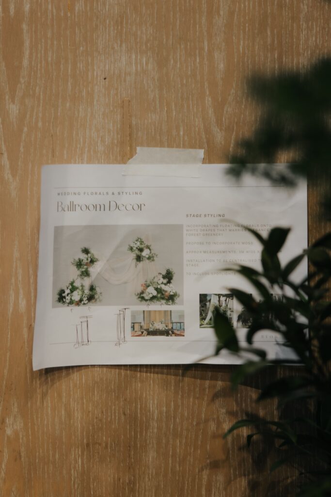 Close up of stage floral arrangement featuring roses, hydrangeas and carnations in white brown green palette at Andaz Singapore