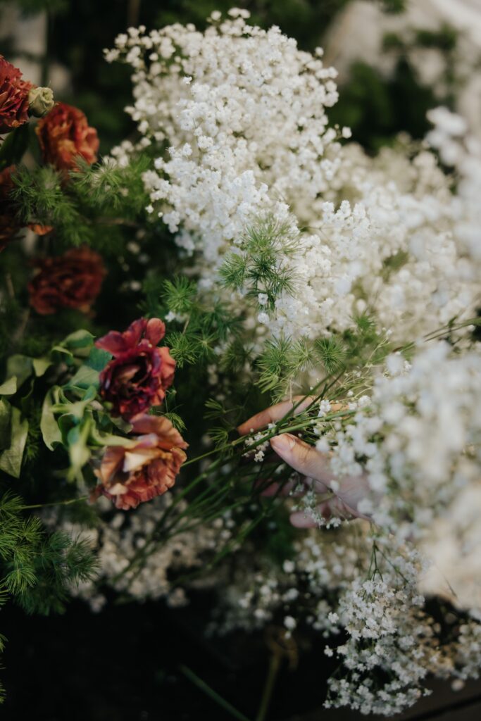 Dense white floral backdrop featuring baby breath, roses and lush greenery in antique garden theme at Andaz Singapore