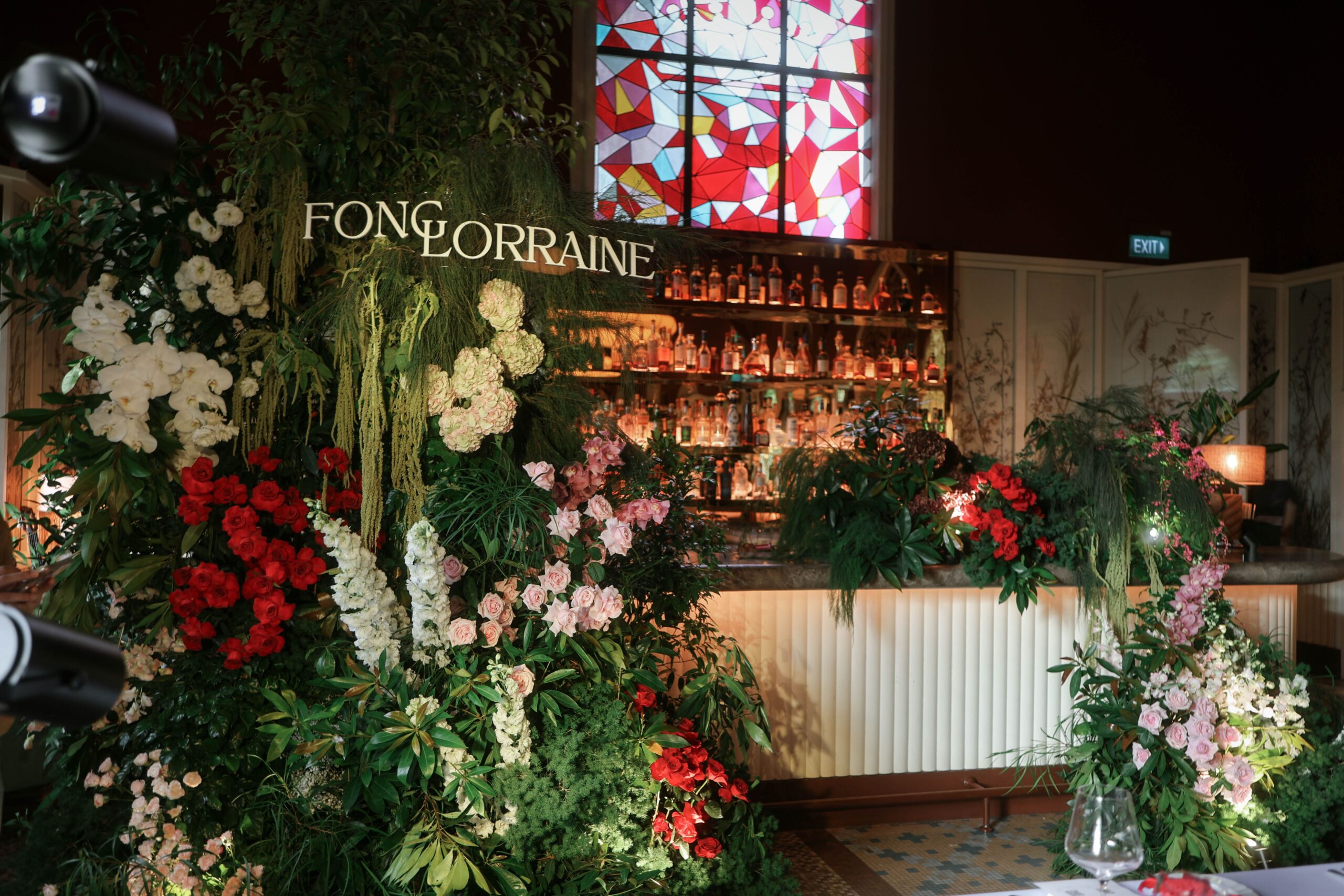 Modern botanical bar installation with white hydrangeas, pink roses, red roses and cascading greenery styled for an intimate wedding dinner, Claudine Singapore