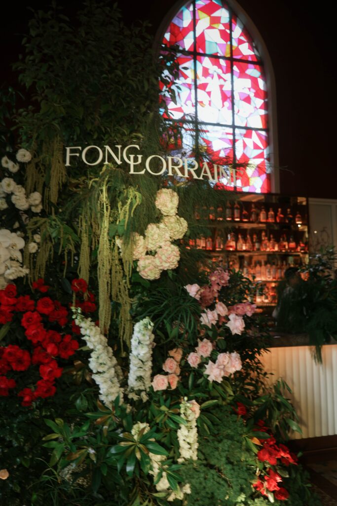 Organic floral backdrop with white hydrangeas, pink and red roses styled against the stained glass window for a modern wedding dinner, Claudine Singapore