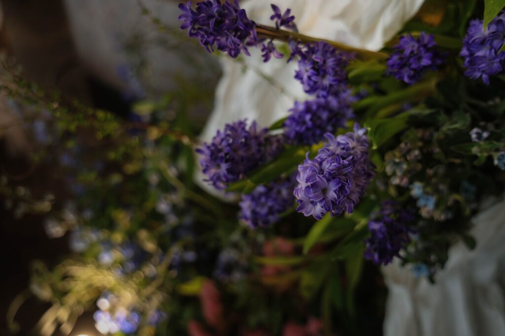 Floral texture detail of the bar backdrop featuring purple flowers, greenery, and layered natural elements, Empress Restaurant Singapore