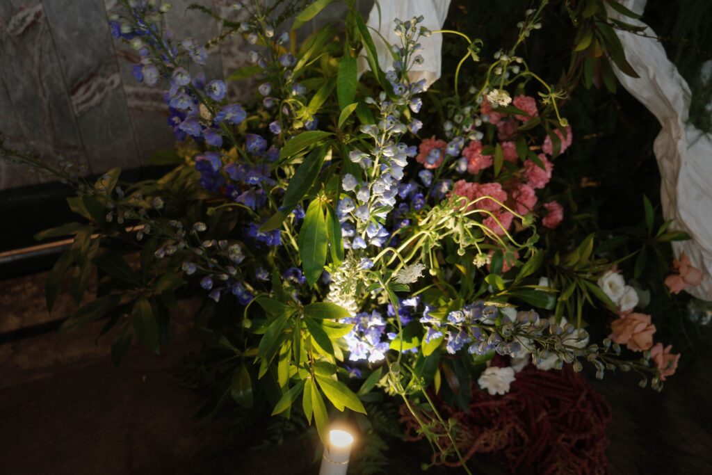 Close-up of fresh flower detailing at the lower section of the bar backdrop with greenery, white and purple blooms, Empress Restaurant Singapore
