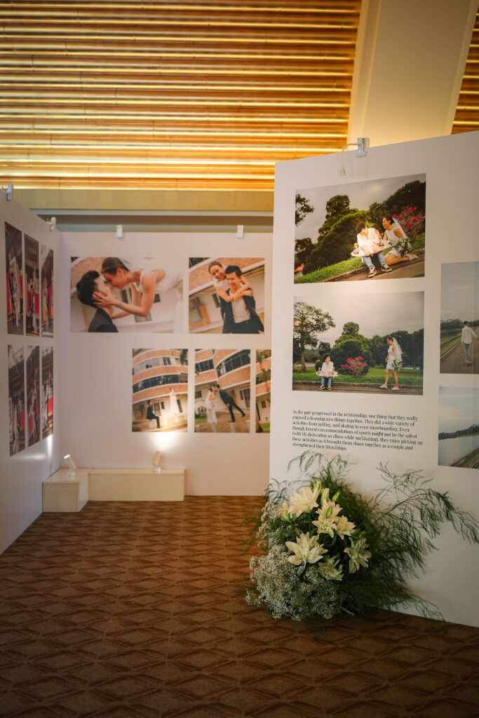Curated memory lane display with framed milestone photographs and organic floral styling in the foyer at The Ritz-Carlton Singapore