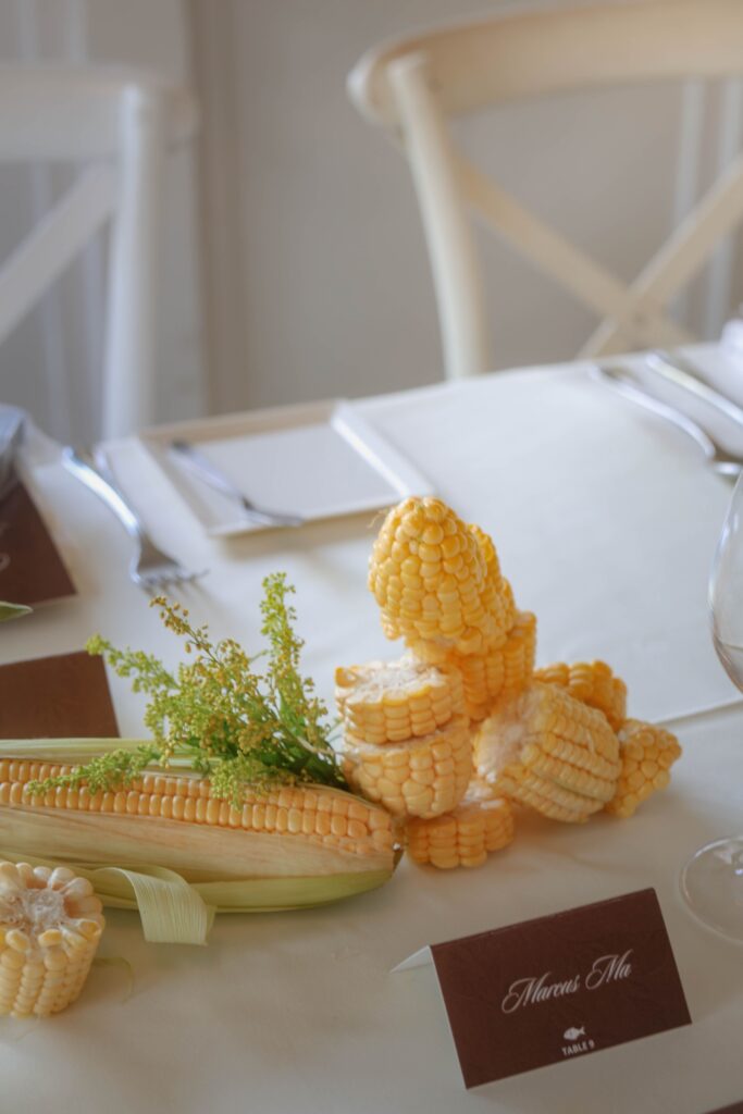 Minimal table styling featuring corn and restrained floral accents styled with intention at The Summerhouse Restaurant Singapore