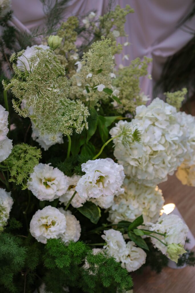 Floral cluster detail with white hydrangeas, lisianthus, and layered greenery forming part of the ceremony installation at Sky Garden Sentosa, Sentosa Singapore