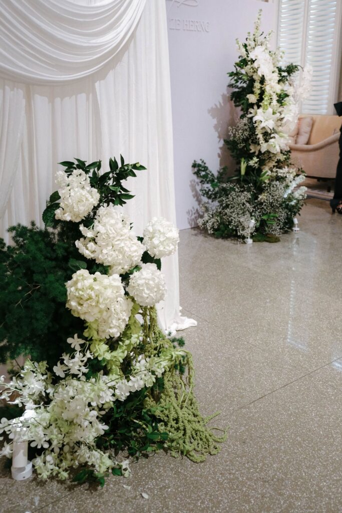 Close-up view of white and green wedding floral arrangement with layered textures and soft greenery accents, The Clifford Pier Singapore