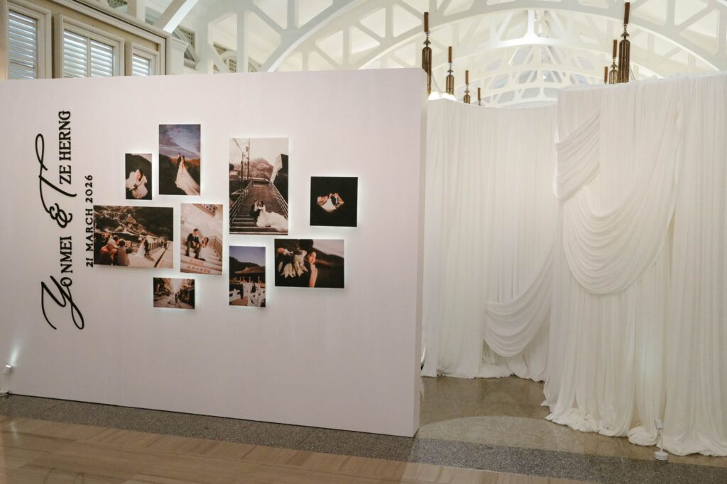 Full view of privacy wall design combining structured panels and curated photo gallery display in wedding styling, The Clifford Pier Singapore