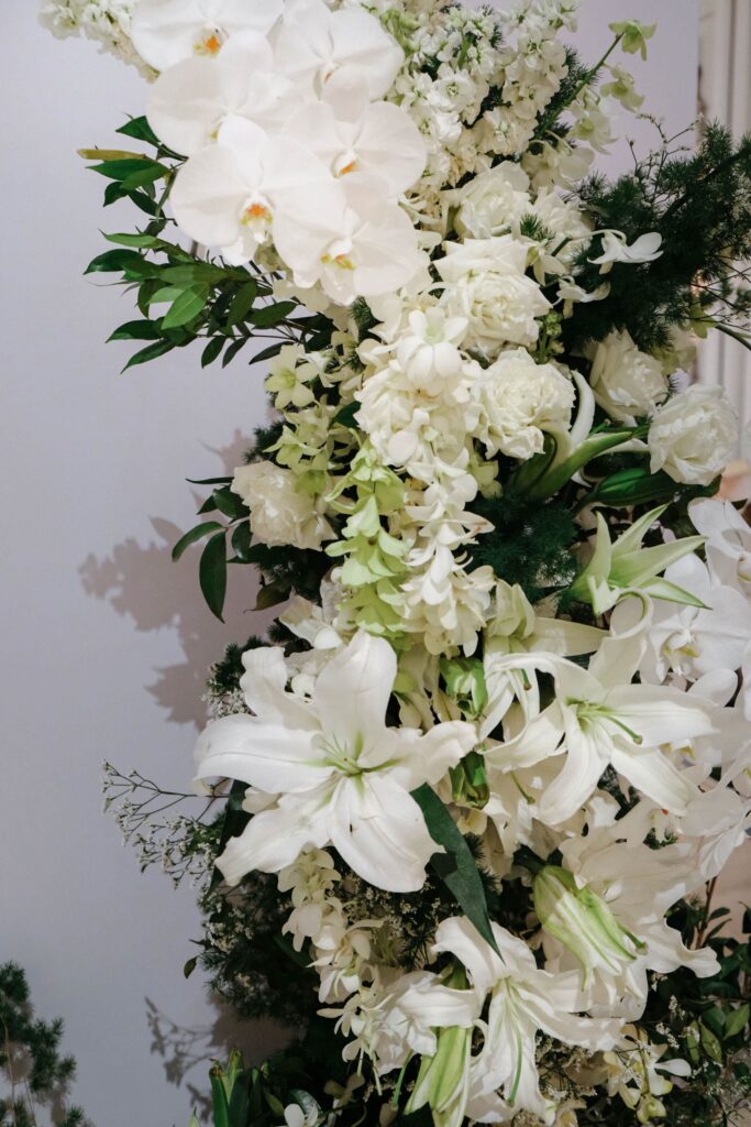 Detailed floral styling featuring white lilies and greenery used in wedding decor arrangements, The Clifford Pier Singapore