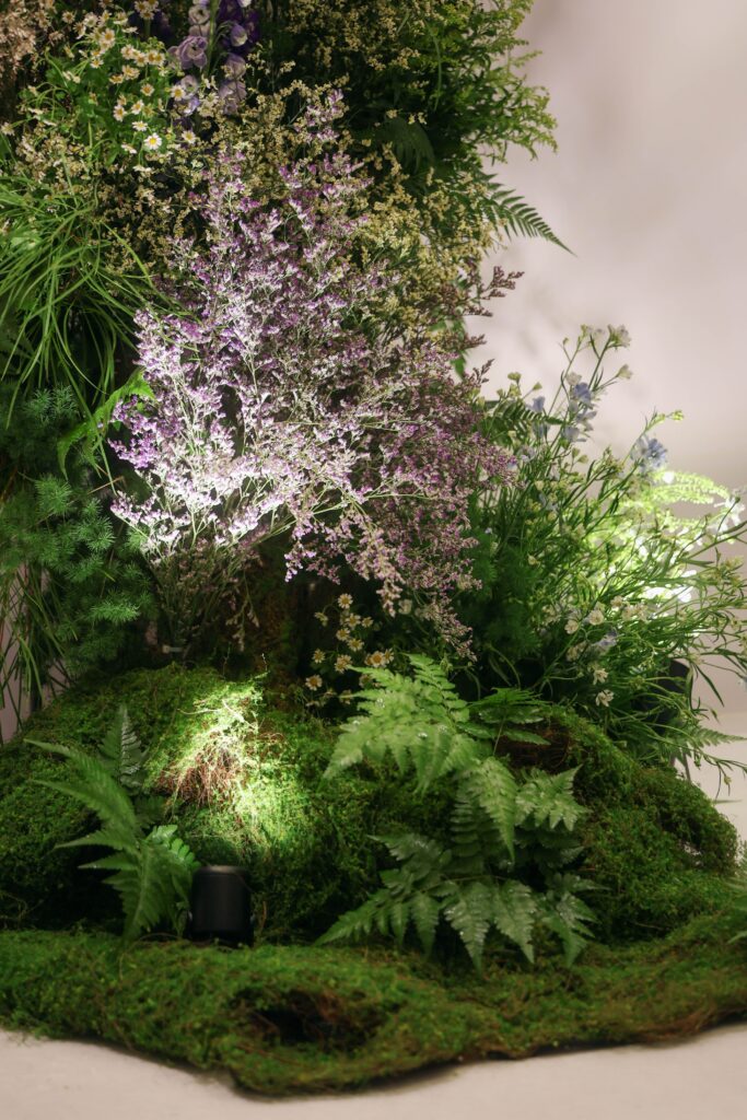 Nature-inspired floral installation featuring lilac flowers, ferns, textured foliage, and layered organic styling designed to resemble a natural alpine landscape at Westin Singapore.