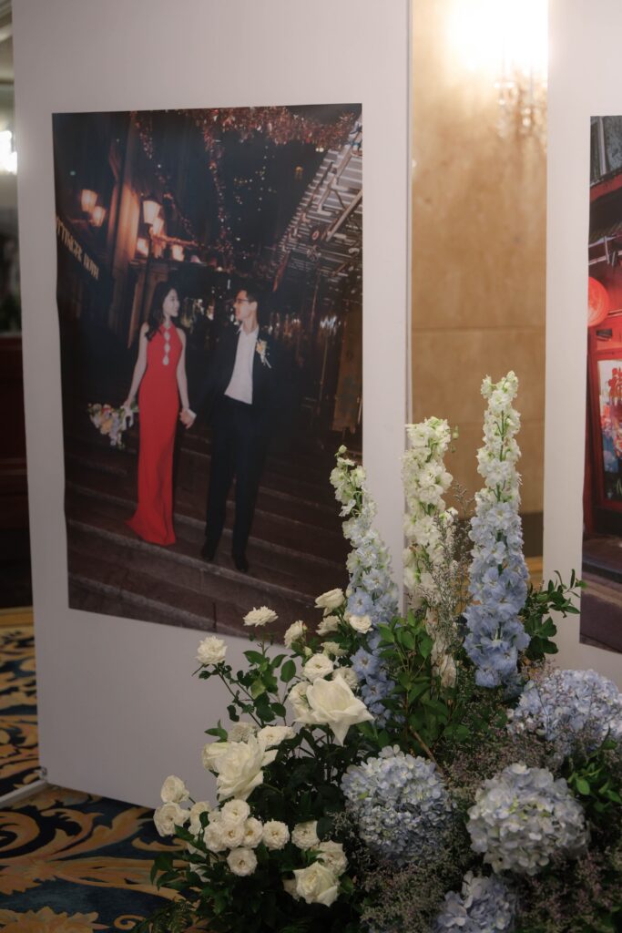 Wedding portrait display framed with lush floral styling featuring hydrangeas and layered greenery in ballroom décor at Shangri-La Singapore