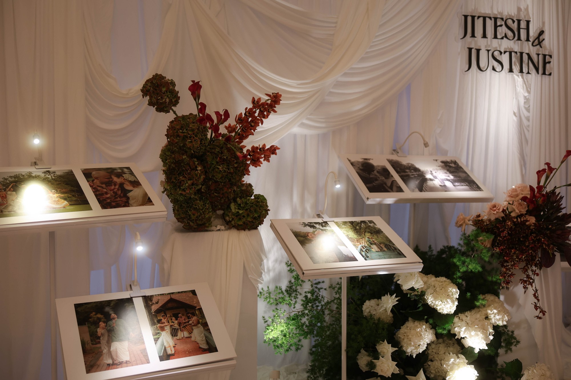 Raffles Hotel wedding photo display with burgundy florals and white hydrangea beneath the couple's name sign