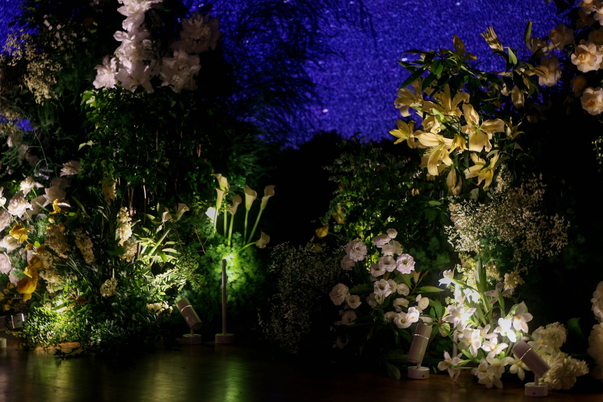 Capella ballroom wedding: starlit meadow installation of yellow and white florals with a mirrored base