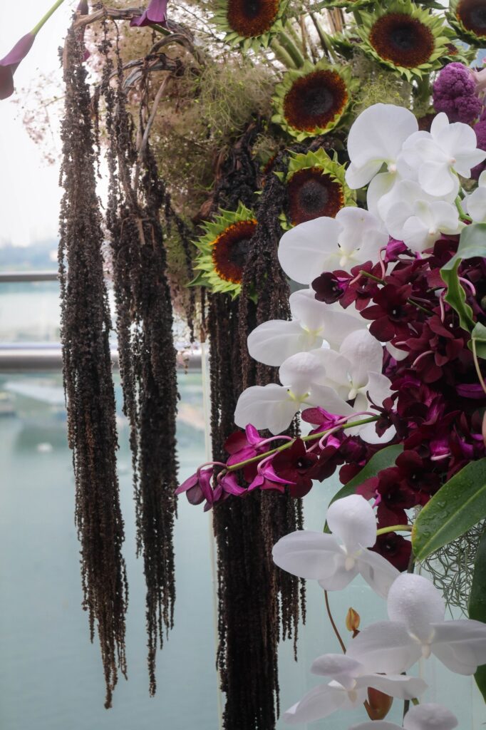 Trailing amaranth and dark sunflowers in a moody installation at a VUE wedding