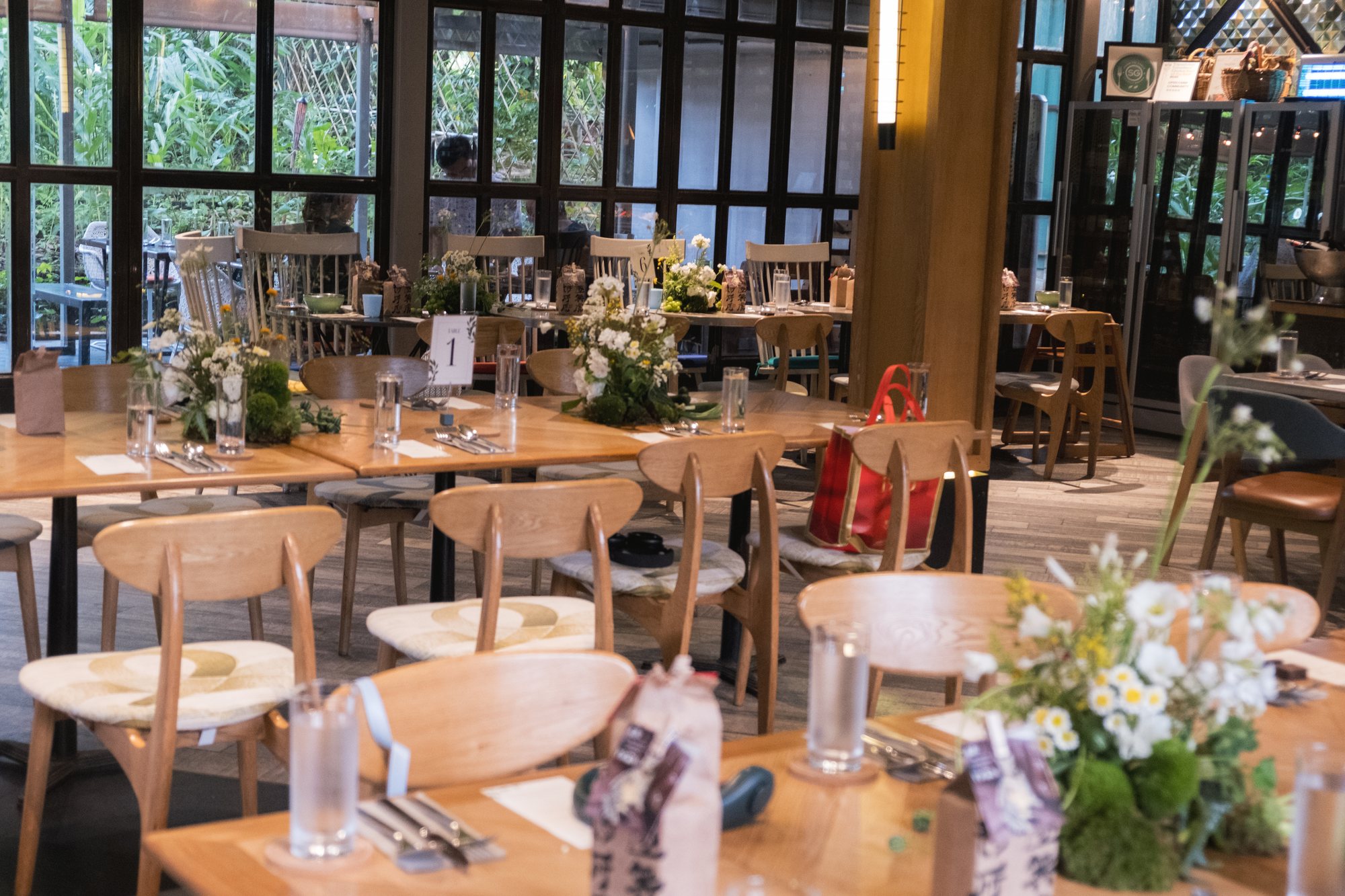 White and yellow florals with fresh vegetables along a wide Open Farm Community wedding table