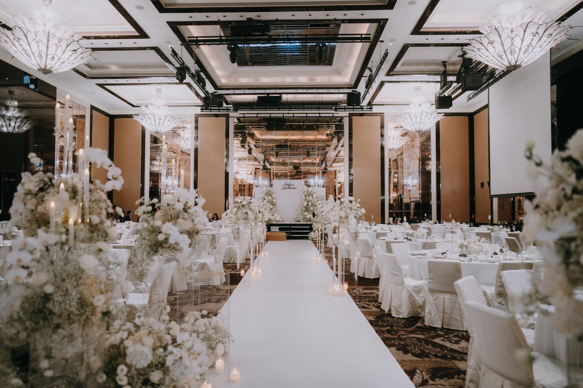 St Regis Armenian Church wedding ballroom aisle in all white with florals and chandeliers